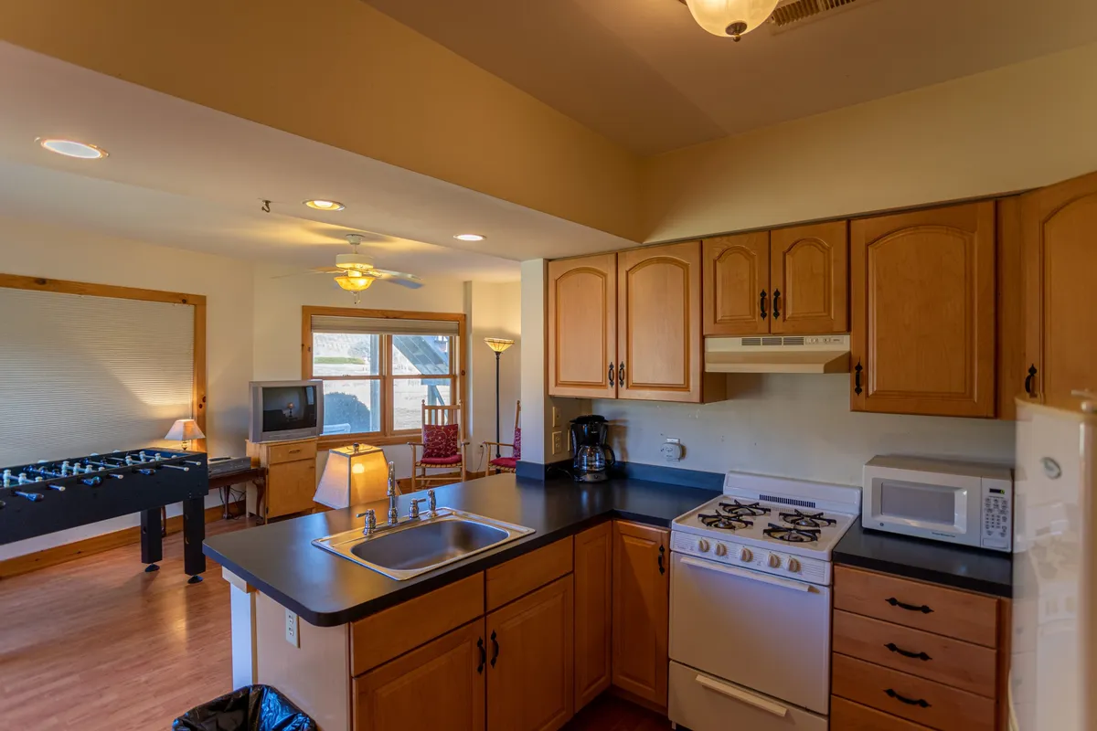 A cozy kitchenette with modern appliances, ample counter space, and a window view, designed for easy meal preparation and snacks. The space feels welcoming and functional, supporting independent routines or midnight snacks.